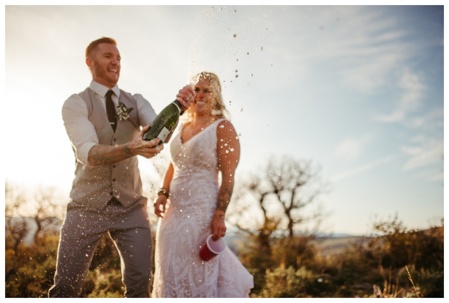 a bride and groom popping champagne on their wedding day in Carbondale, CO