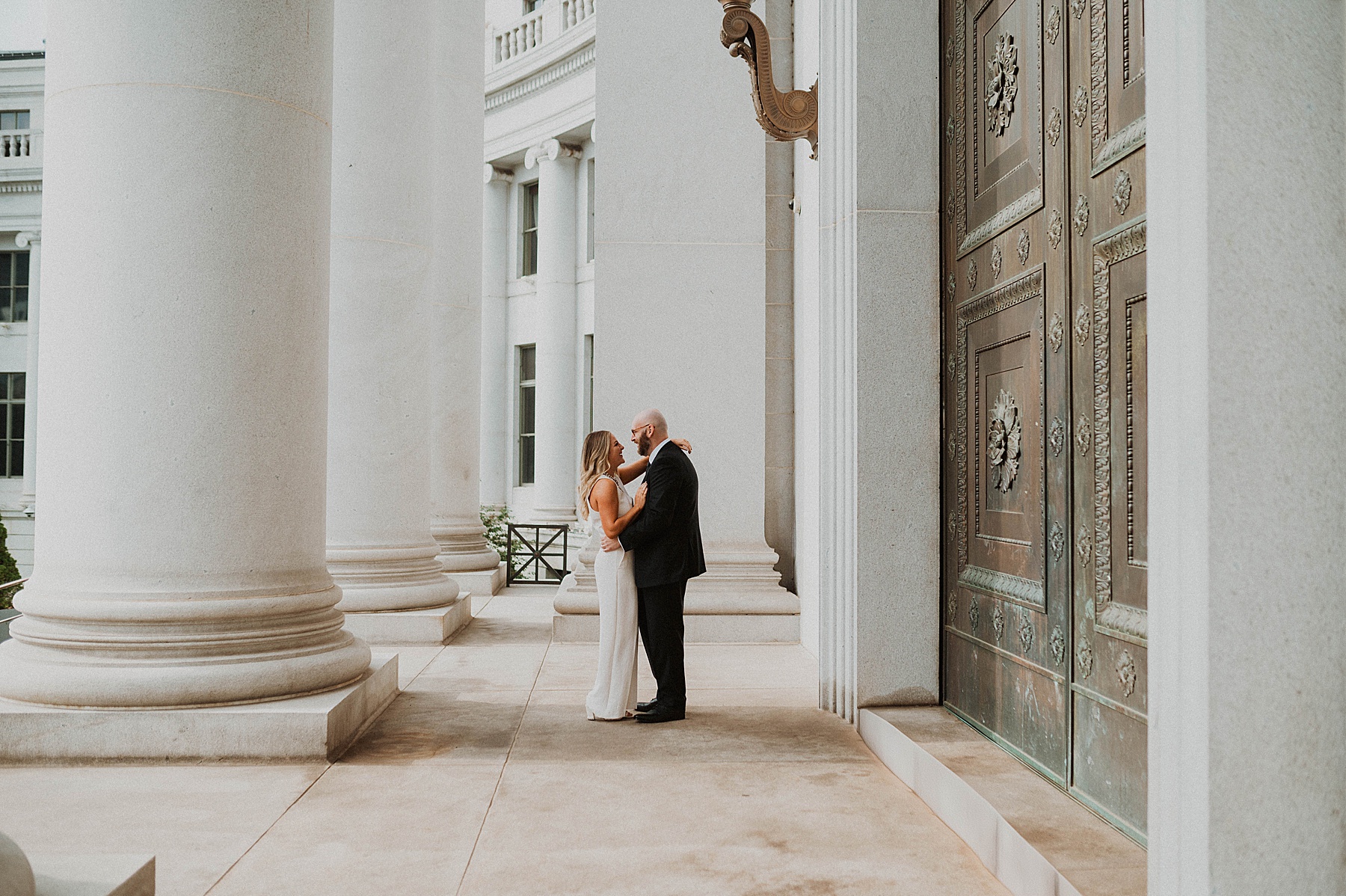 a couple doing denver engagement photos at the courthouse