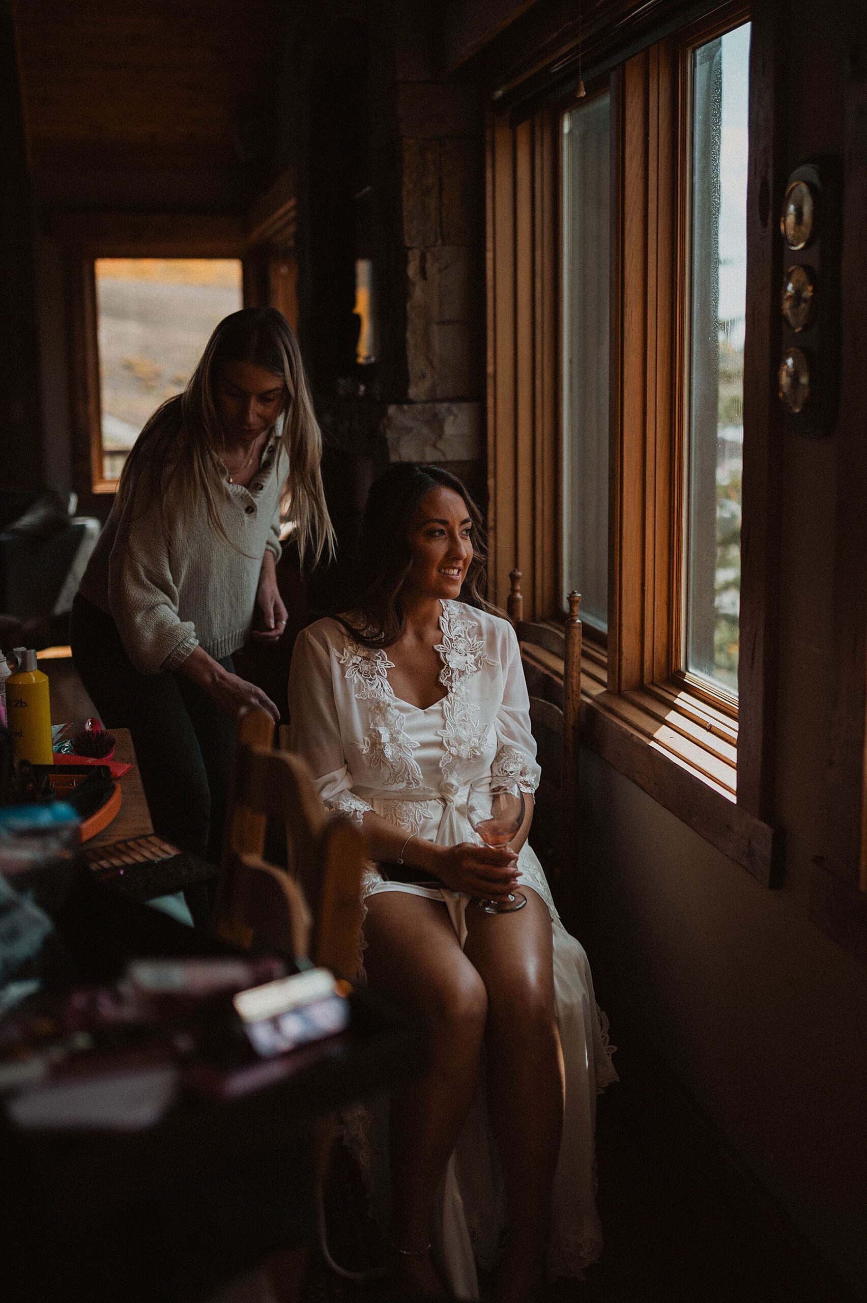 bride getting ready at an airbnb in crested butte on her wedding day with Natalie Duke Beauty