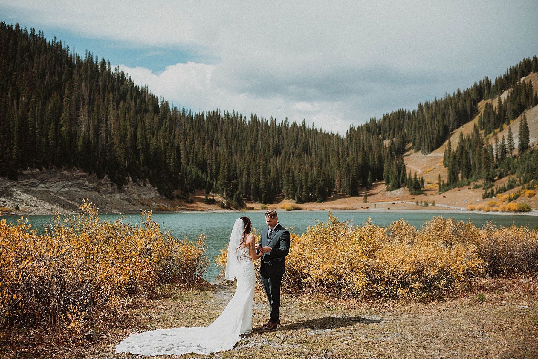 bride and groom first look at emerald lake in crested butte on their wedding day