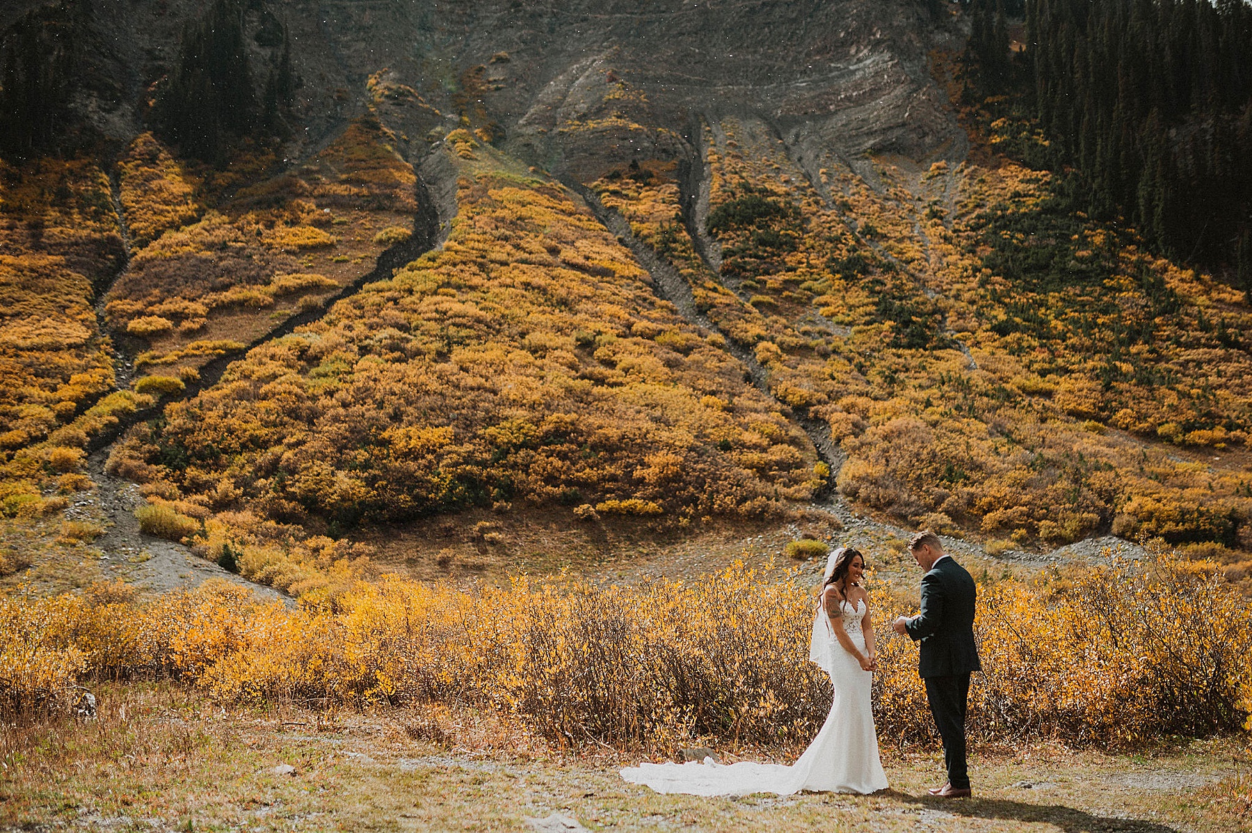 bride and groom first look at emerald lake in crested butte on their wedding day