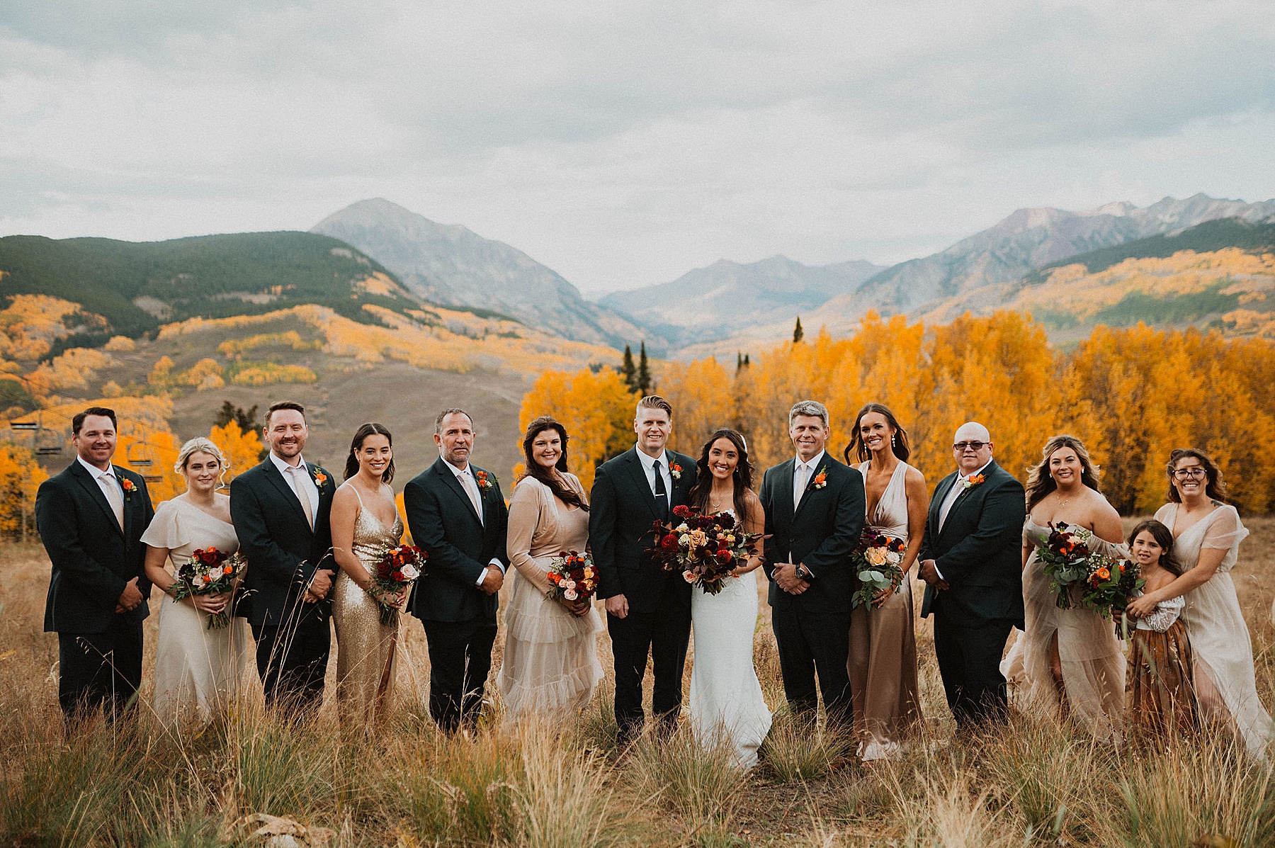 wedding party with bride and groom at ten peaks at crested butte resort in crested butte with bramble and bloom florals