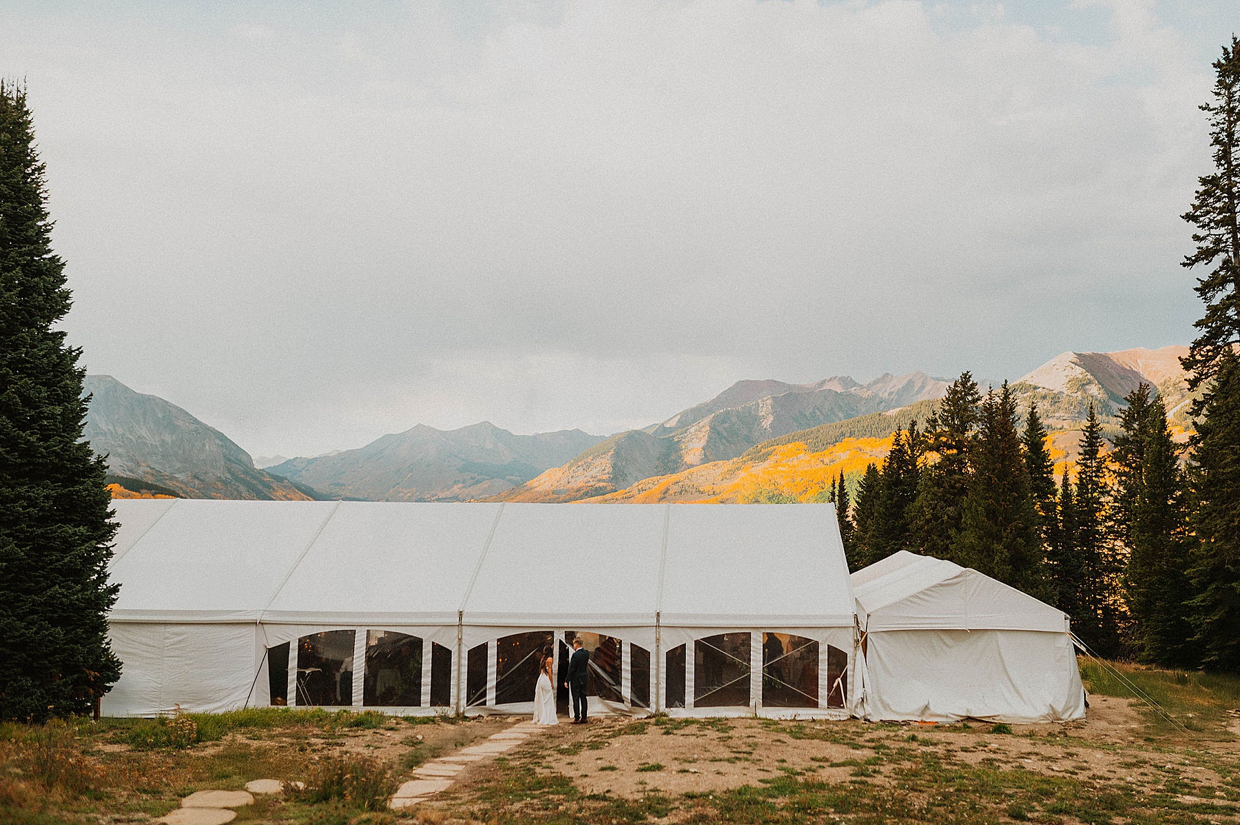 bride and groom walking in their reception on Ten Peaks at Crested Butte resort in the fall