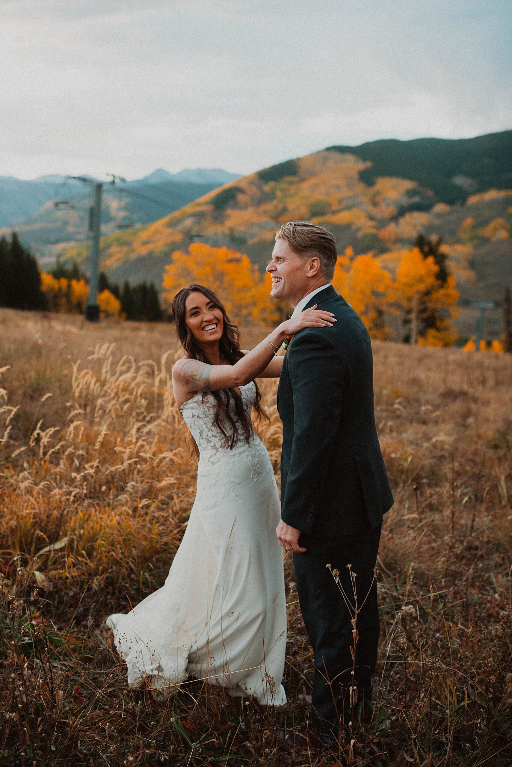 bride and groom on their wedding day at Ten peaks, overlooking the mountains at sunset at the Crested Butte Resort