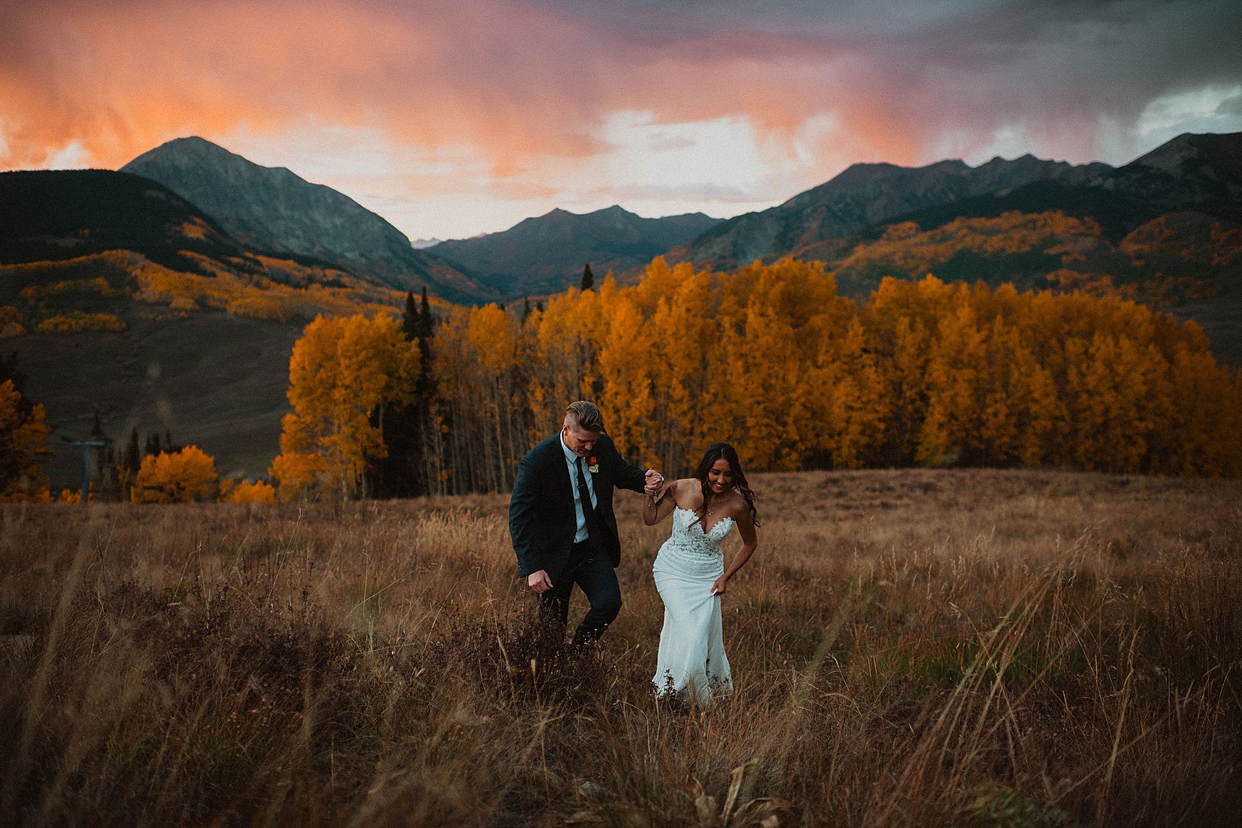 bride and groom on their wedding day at Ten peaks, overlooking the mountains at sunset at the Crested Butte Resort