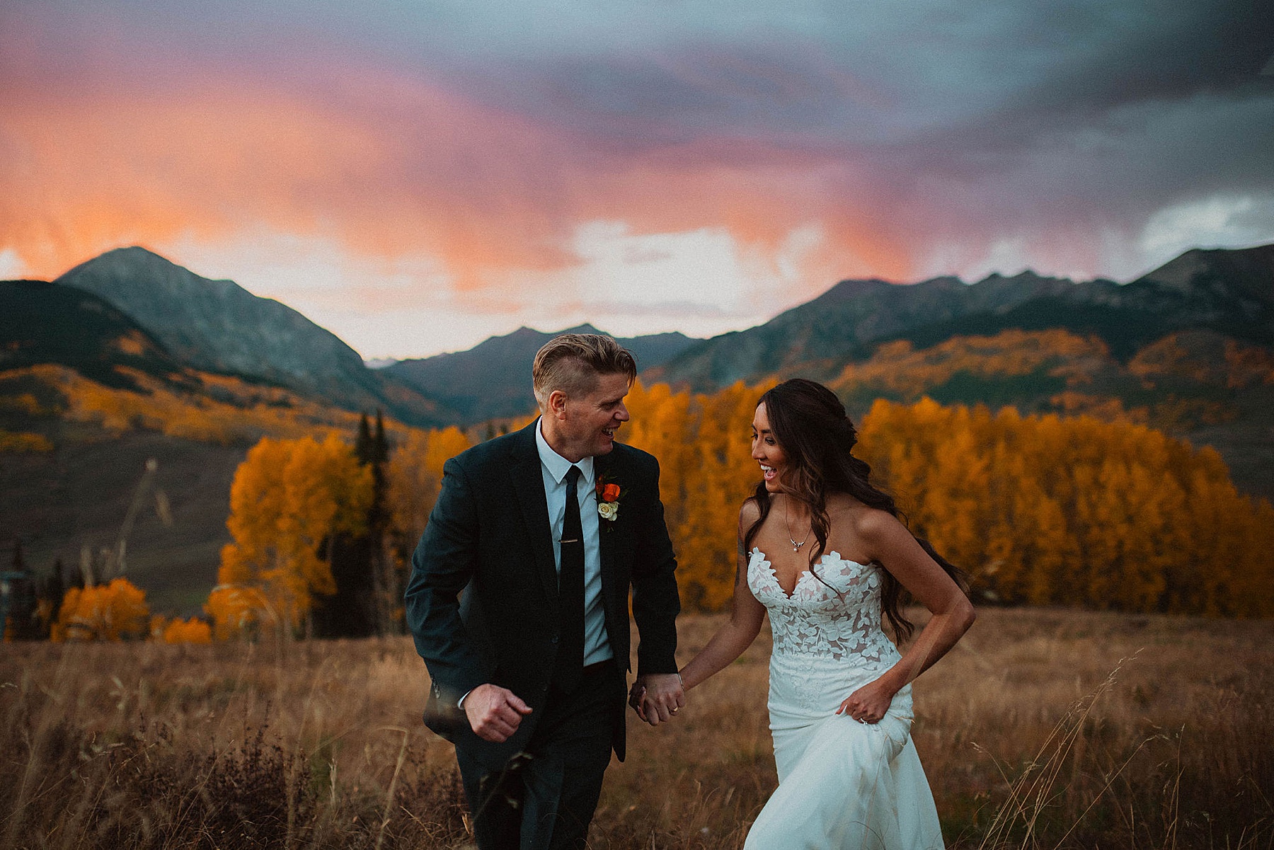 bride and groom on their wedding day at Ten peaks, overlooking the mountains at sunset at the Crested Butte Resort