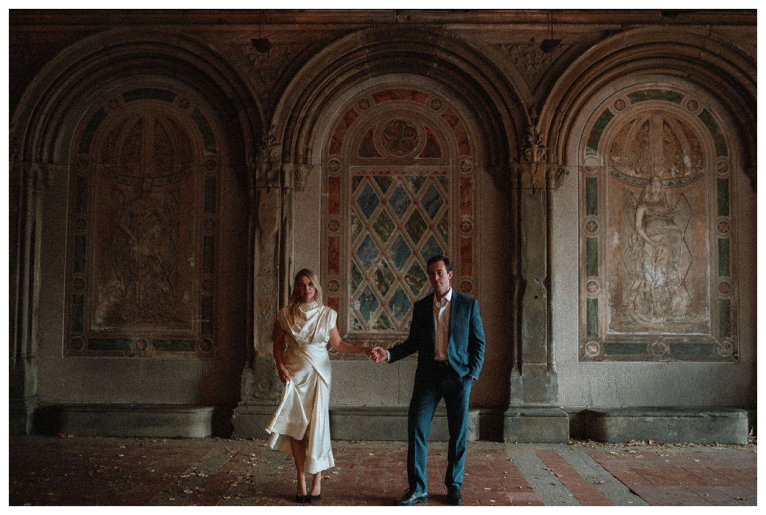 bride and groom at bethesda terrace in central park for an engagement session. NYC wedding photographer.