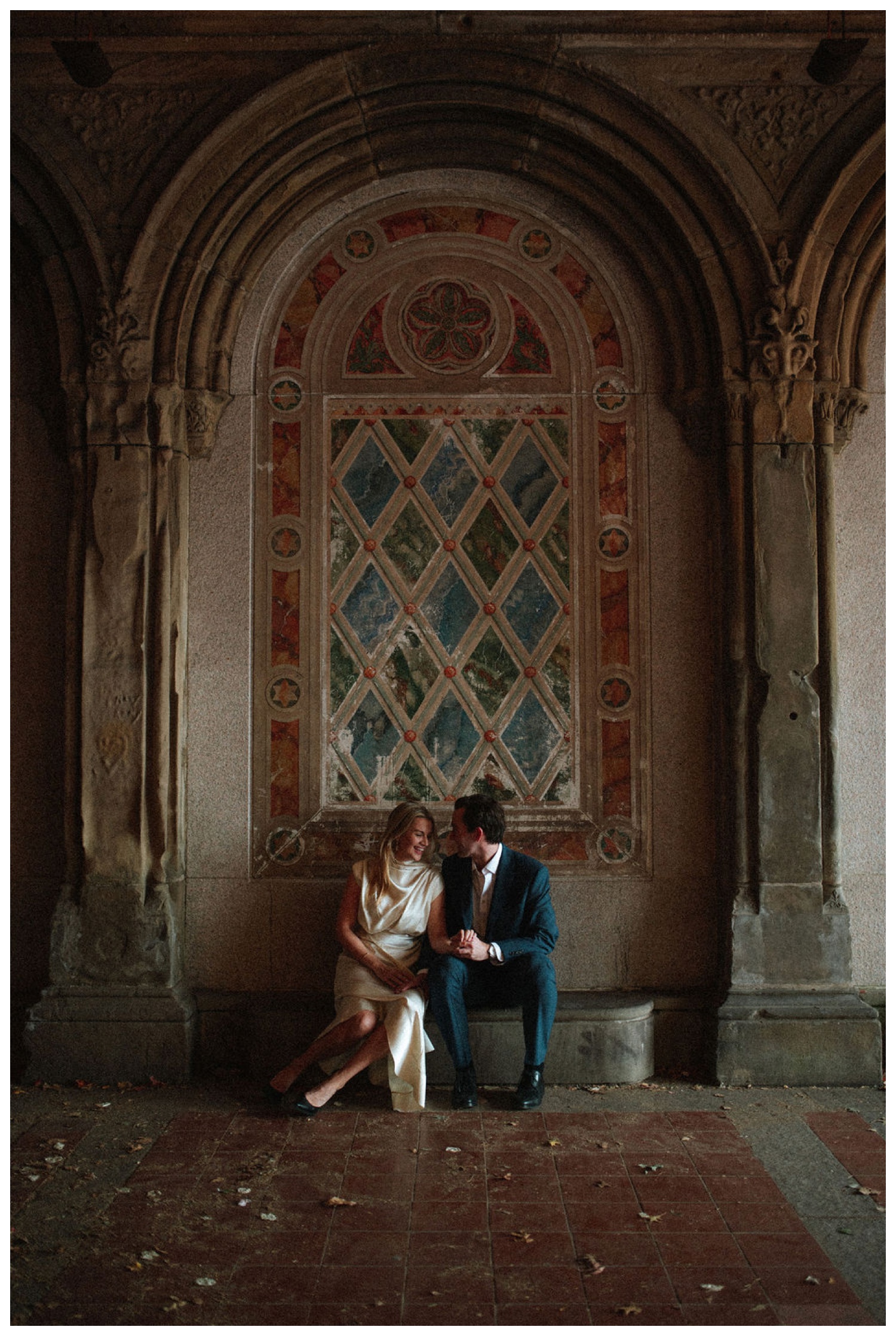bride and groom at bethesda terrace in central park for an engagement session. NYC wedding photographer.