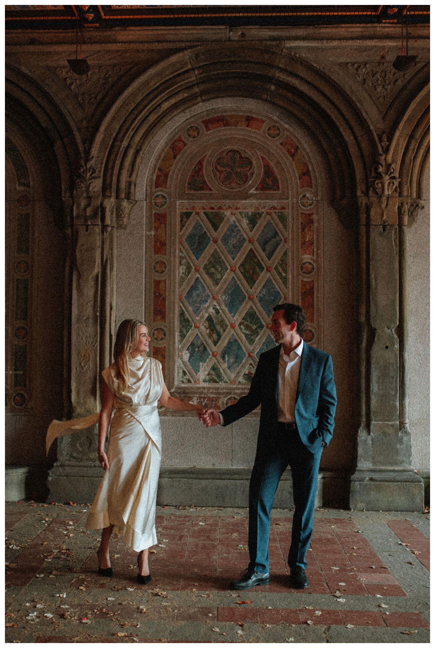 bride and groom at bethesda terrace in central park for an engagement session. NYC wedding photographer.