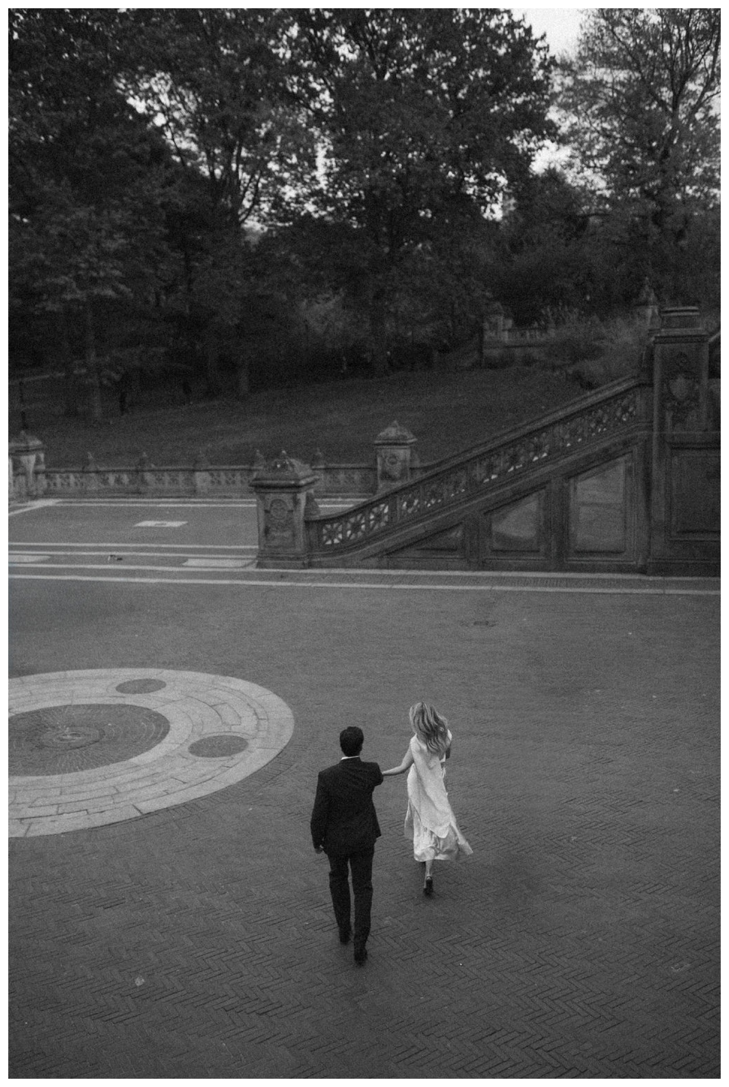 bride and groom at bethesda terrace in central park for an engagement session. NYC wedding photographer.