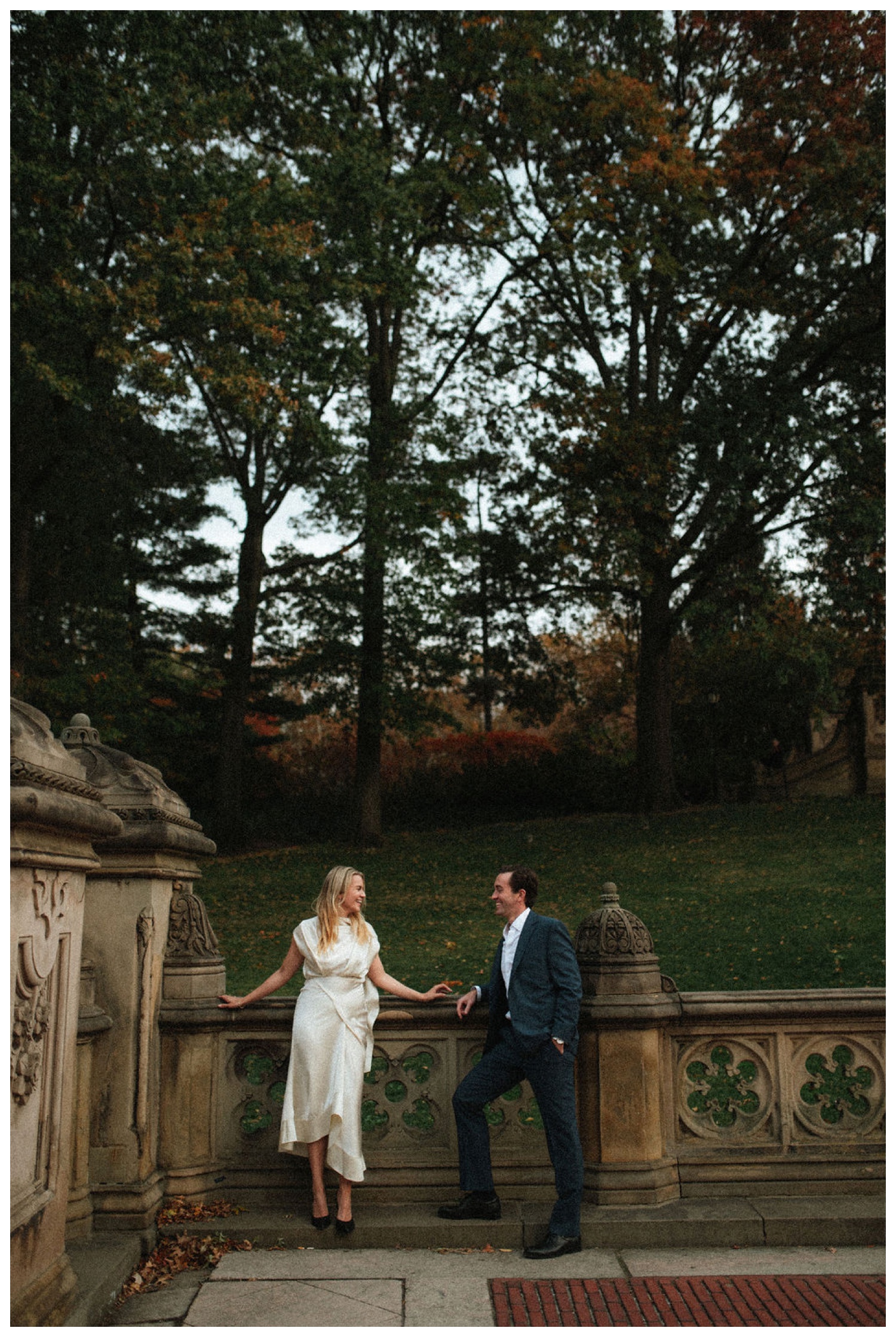 bride and groom at bethesda terrace in central park for an engagement session. NYC wedding photographer.