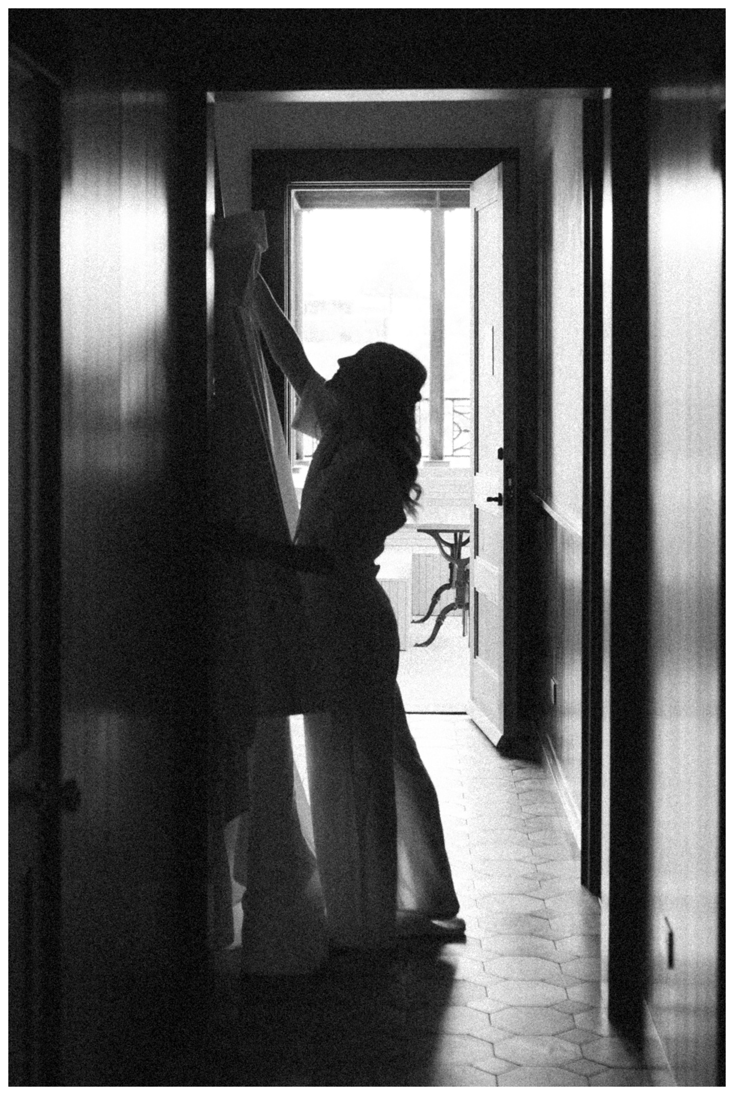 Bride admiring her wedding dress in the Surf House of the Surf hotel in Buena Vista, Colorado. Luxury wedding. Colorado Wedding Photographer. 