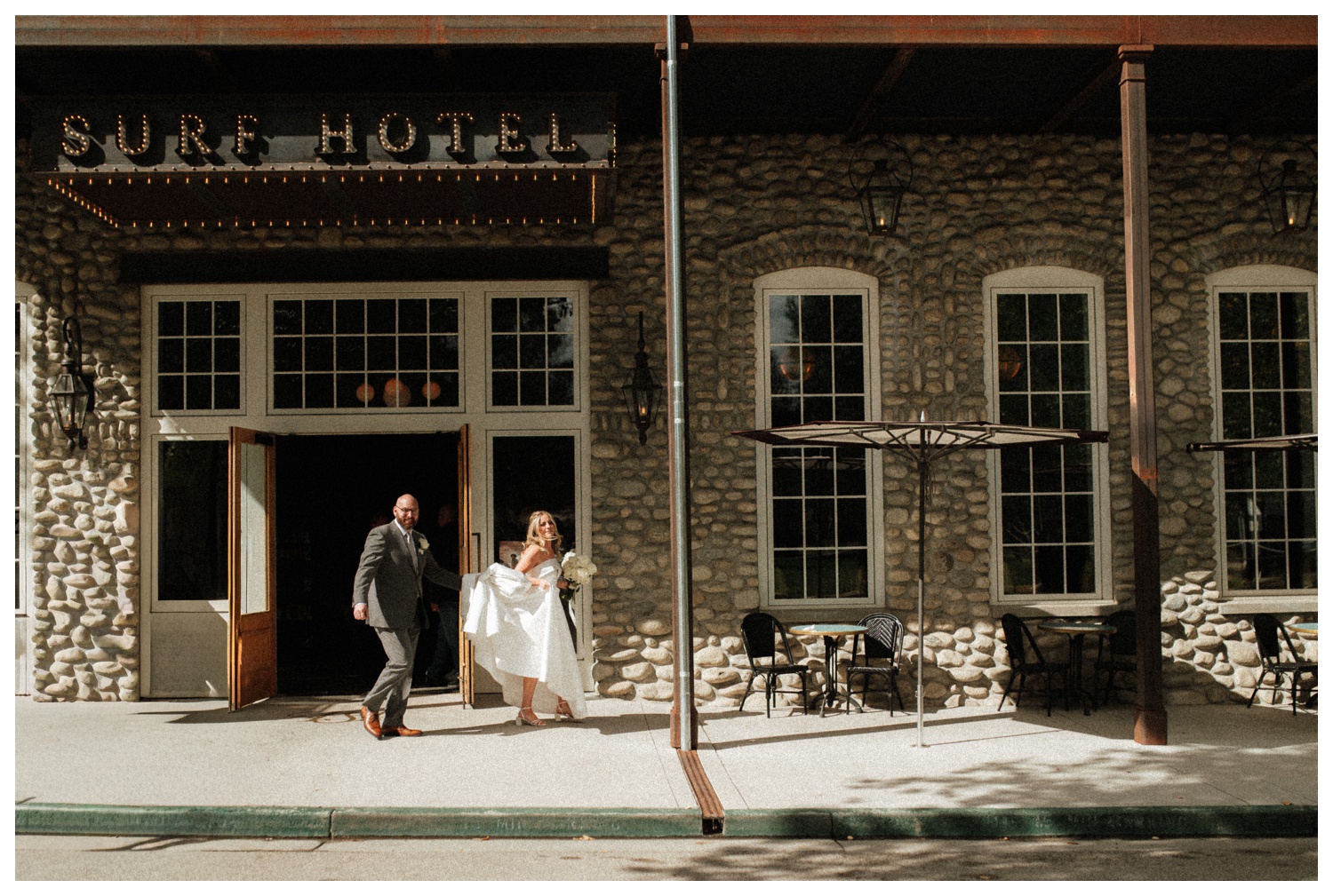 A bride and groom on their wedding day walking out of Surf Hotel in BV. Surf Hotel wedding. Colorado Wedding Photographer.