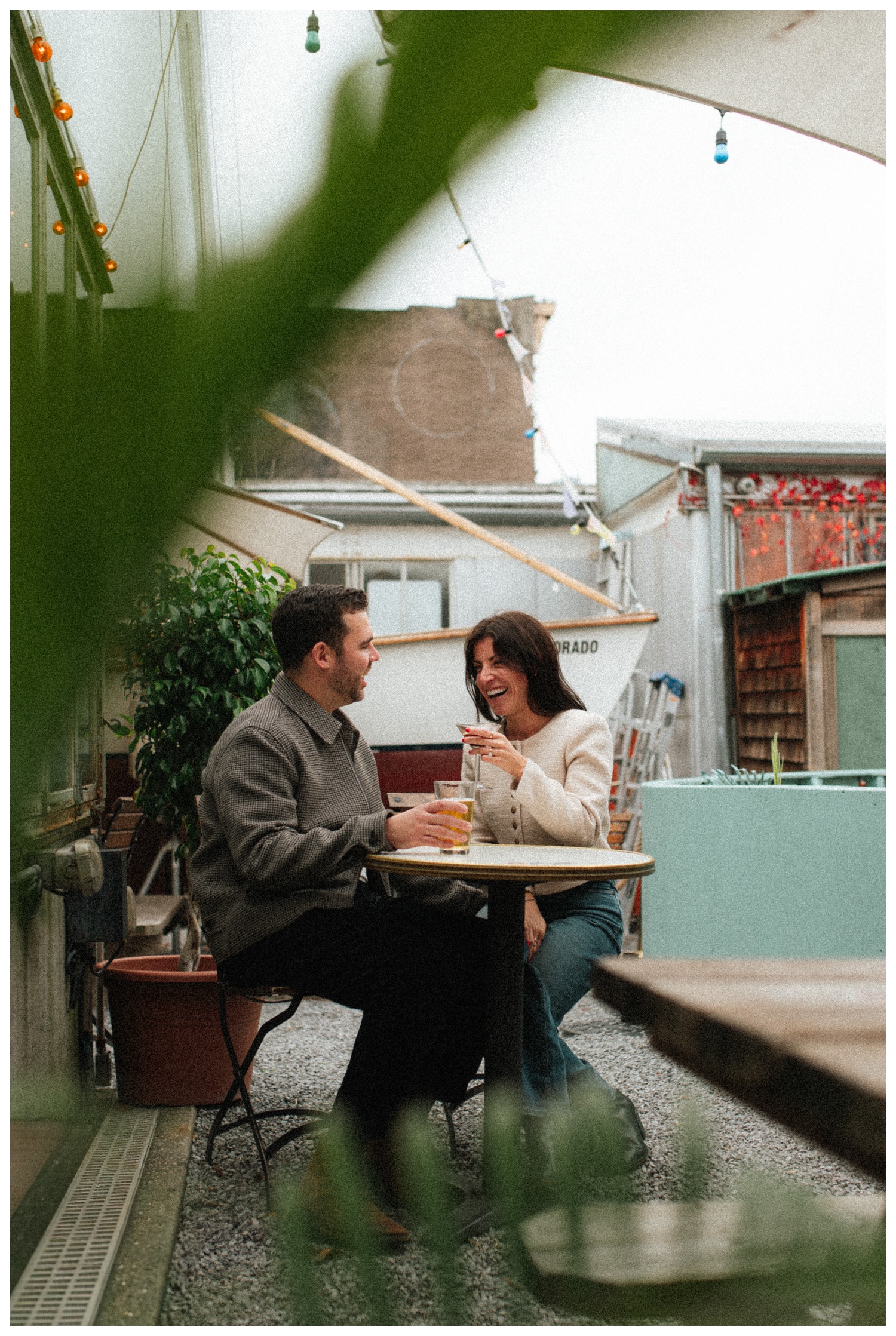 Engaged couple drinking martinis at Grand Torino bar in Williamsburg Brooklyn. Brooklyn wedding photographer.