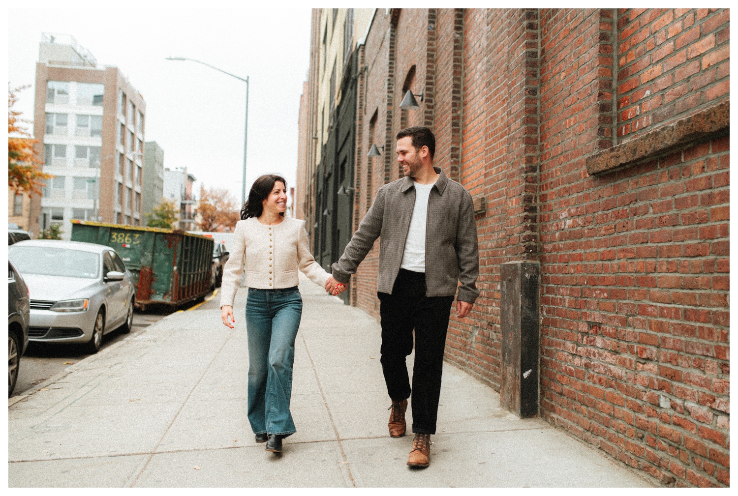 Engaged couple walking through the streets of Williamsburg Brooklyn.