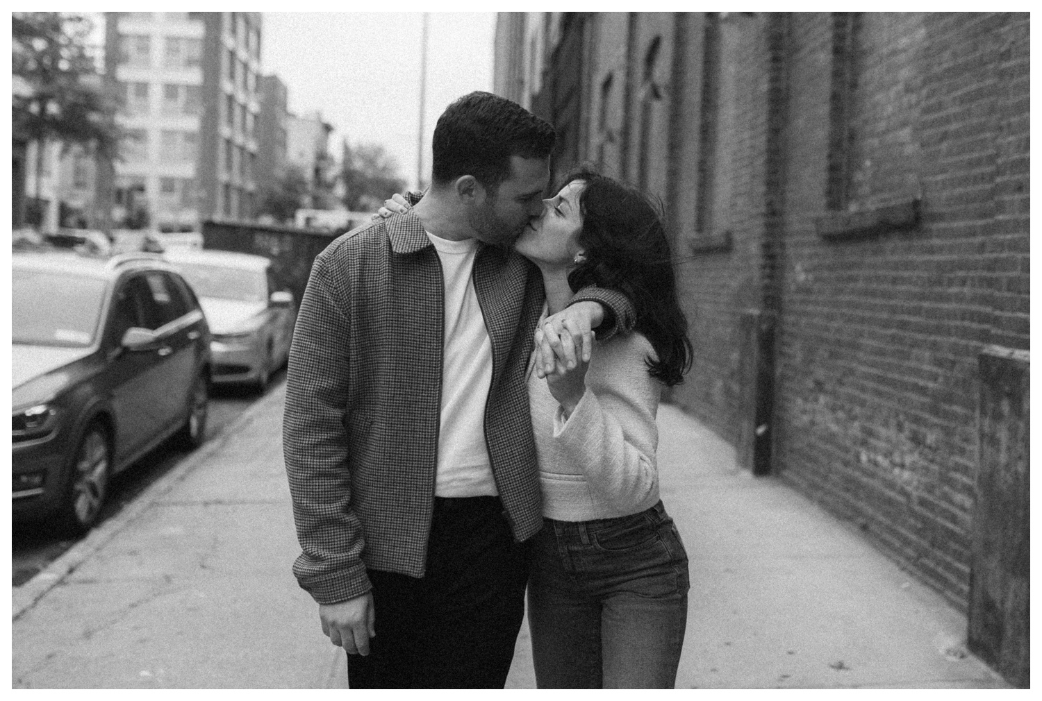 Engaged couple laughing and hugging as they walk down the streets of Williamsburg Brooklyn to their favorite bar. Brooklyn Wedding Photographer. Parr Photo Co
