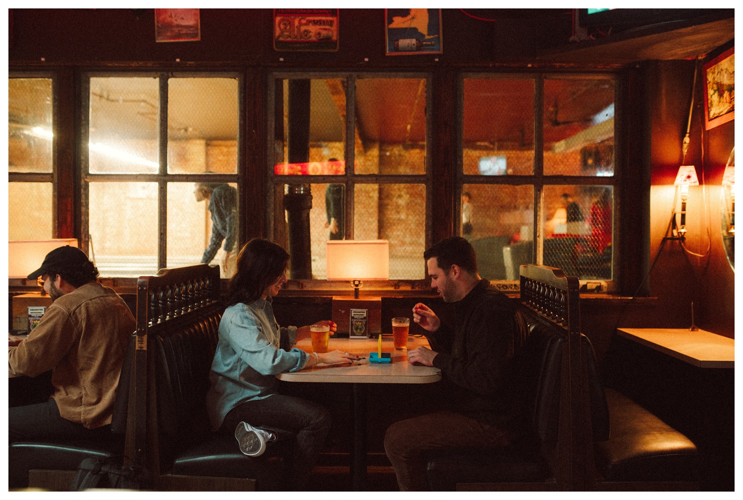 Engaged couple playing Connect Four at THE GUTTER bowling alley for their engagement session in Williamsburg Brooklyn. Brooklyn Wedding Photographer. Parr Photo Co