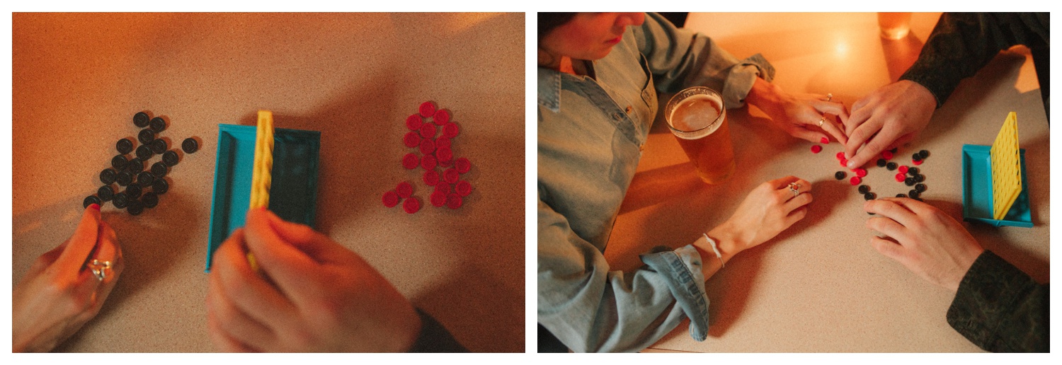 Engaged couple playing Connect Four at THE GUTTER bowling alley for their engagement session in Williamsburg Brooklyn.