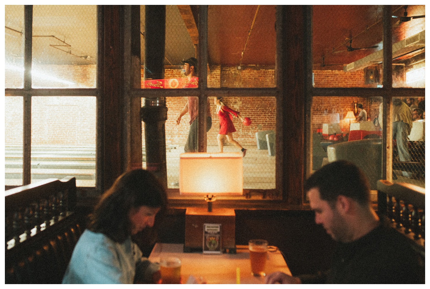 Engaged couple playing Connect Four at THE GUTTER bowling alley for their engagement session in Williamsburg Brooklyn. Brooklyn Wedding Photographer. Parr Photo Co