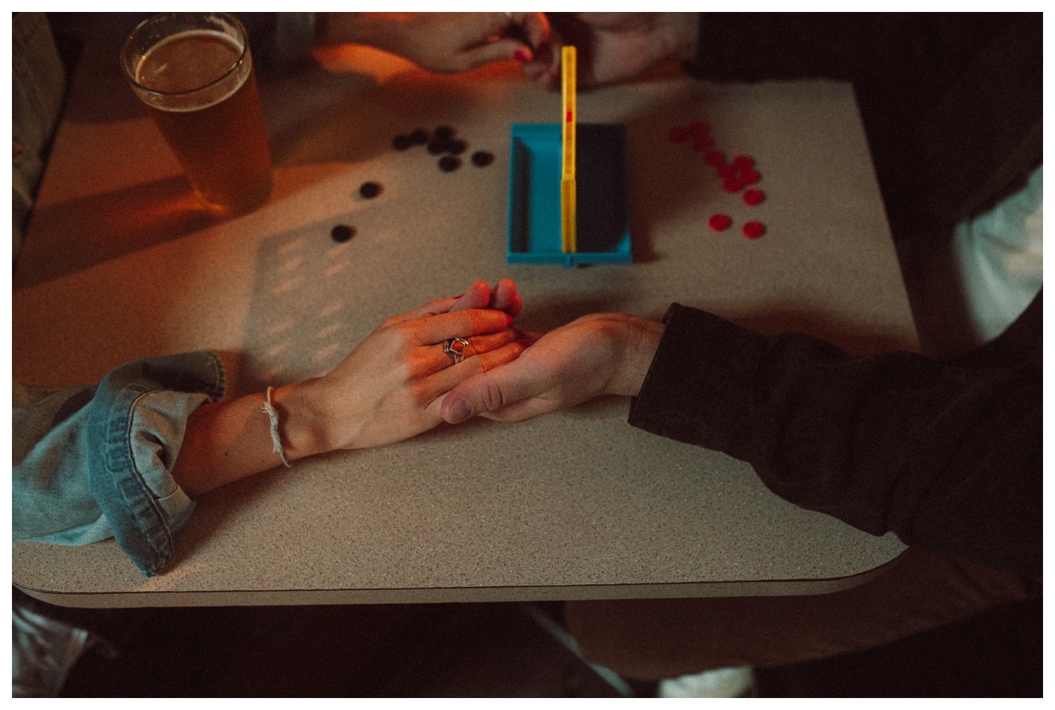 Engaged couple playing Connect Four at THE GUTTER bowling alley for their engagement session in Williamsburg Brooklyn. Brooklyn Wedding Photographer. Parr Photo Co