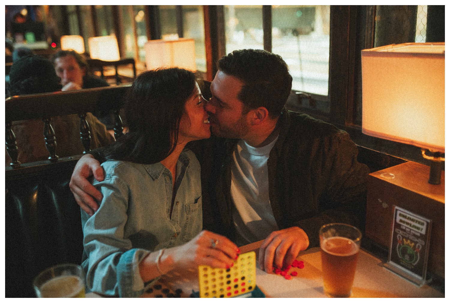 Engaged couple playing Connect Four at THE GUTTER bowling alley for their engagement session in Williamsburg Brooklyn. Brooklyn Wedding Photographer. Parr Photo Co