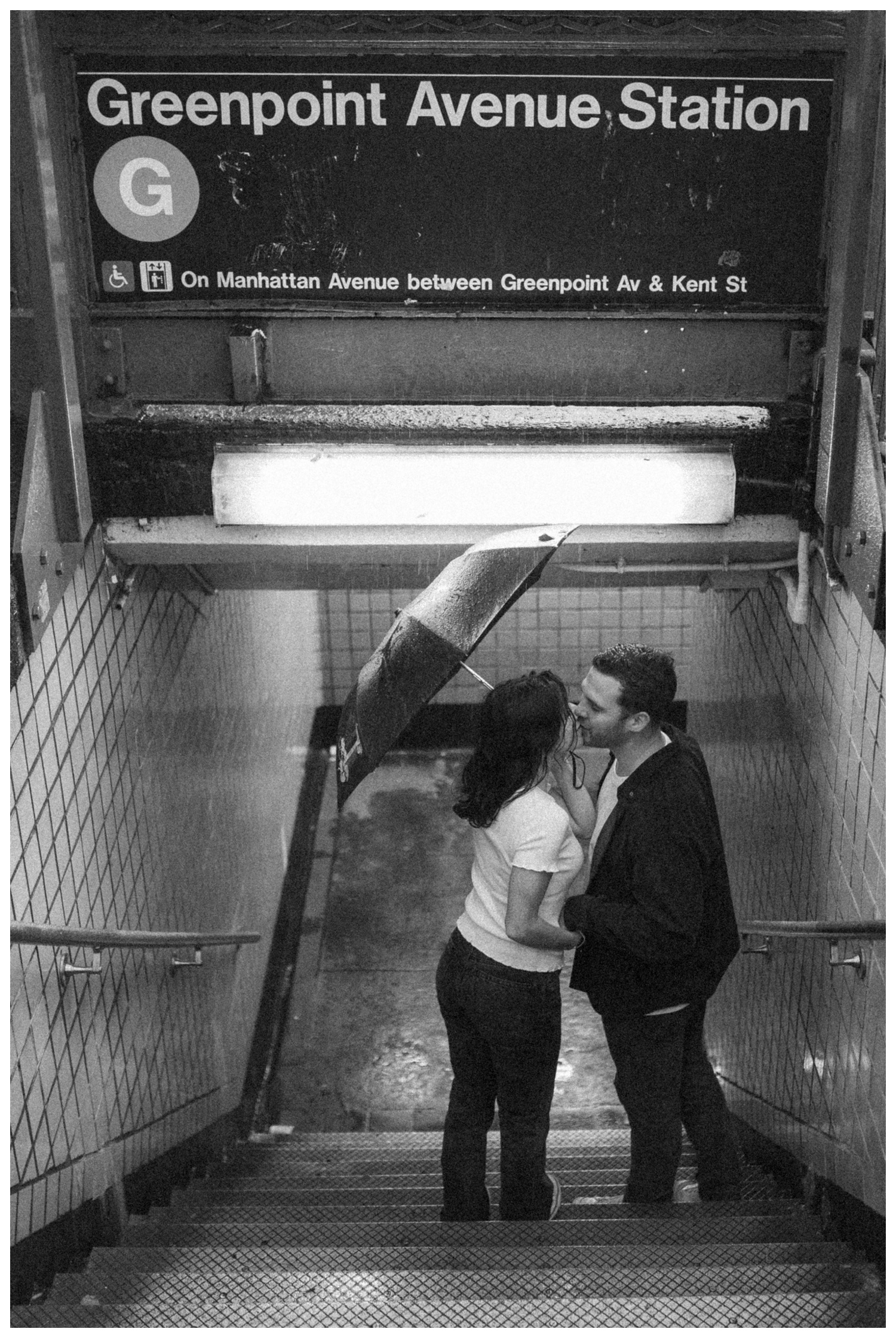 Engaged couple walking down the Greenpoint subway station. Brooklyn Wedding Photographer
