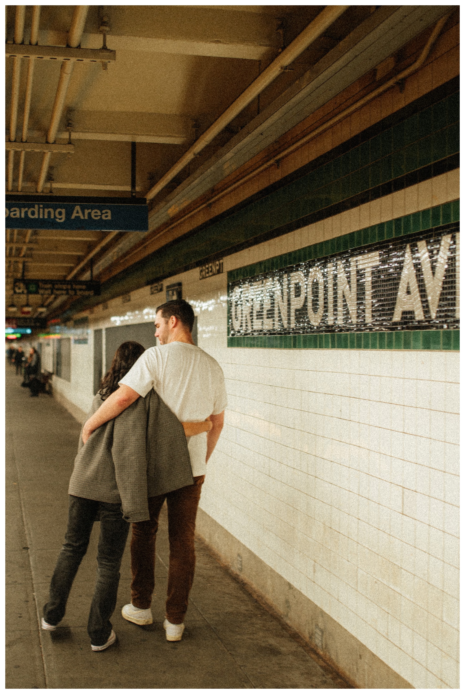 Engaged couple walking down the Greenpoint subway station. Brooklyn Wedding Photographer
