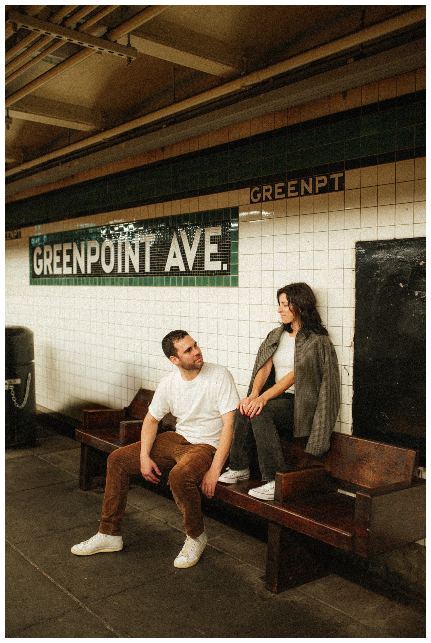 Engaged couple walking down the Greenpoint subway station. Brooklyn Wedding Photographer