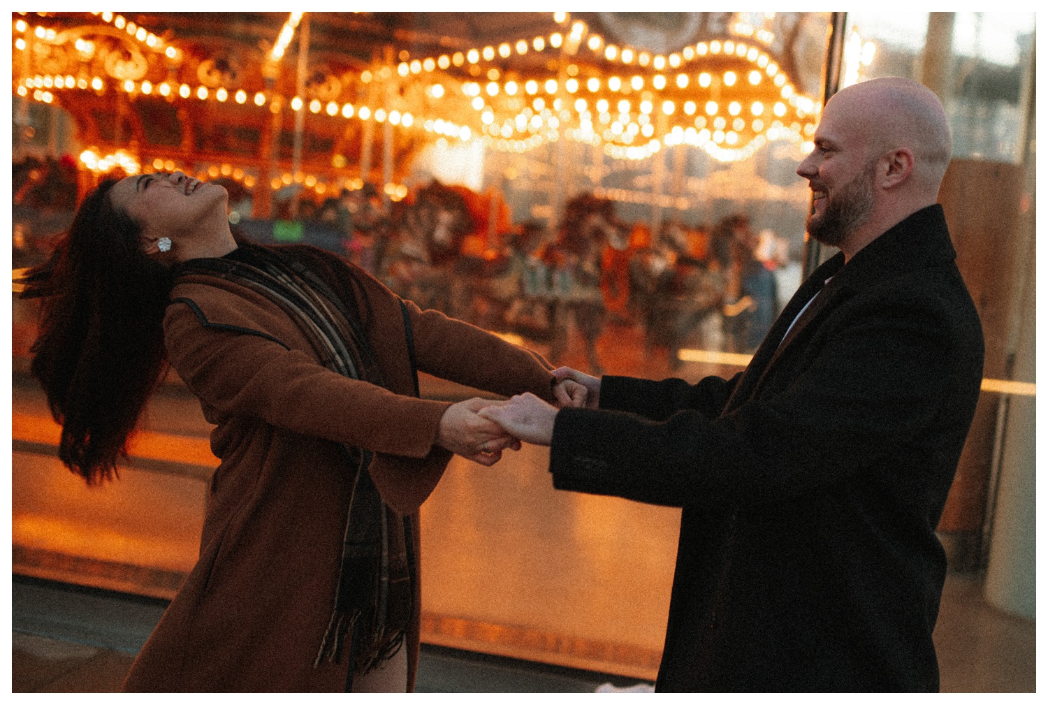 Bride and groom running in front of Jane's Carousel lit up in the evening at Brooklyn Bridge Park in downtown Brooklyn. New York City wedding photographer. Brooklyn wedding photographer. Parr Photo Co. 