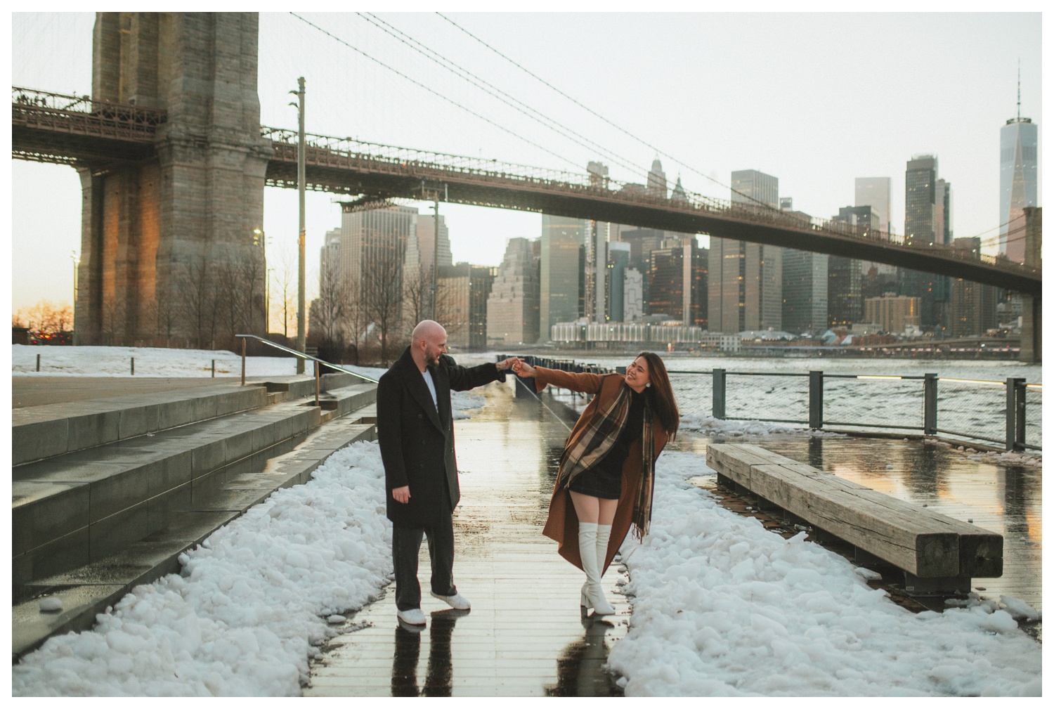 An engaged couple walking in front of the Manhattan skyline at Brooklyn Bridge Park for their engagement session. New York City wedding photographer. Brooklyn wedding photographer. Parr Photo Co.