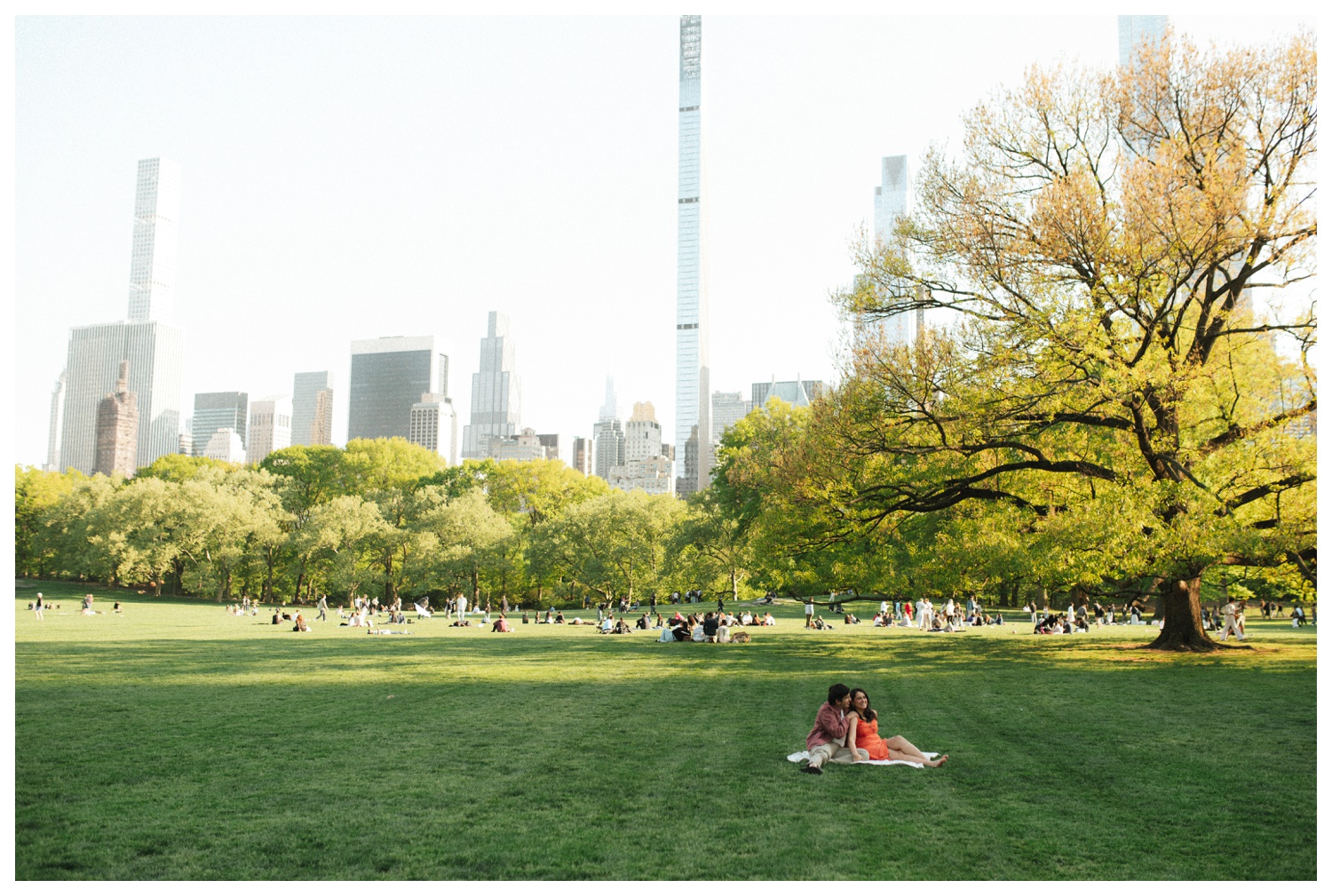 A candid moment of a couple sitting on a blanket at Sheep Meadow in Central Park NYC. Parr Photo Co. NYC wedding photographer. Brooklyn Wedding Photographer.