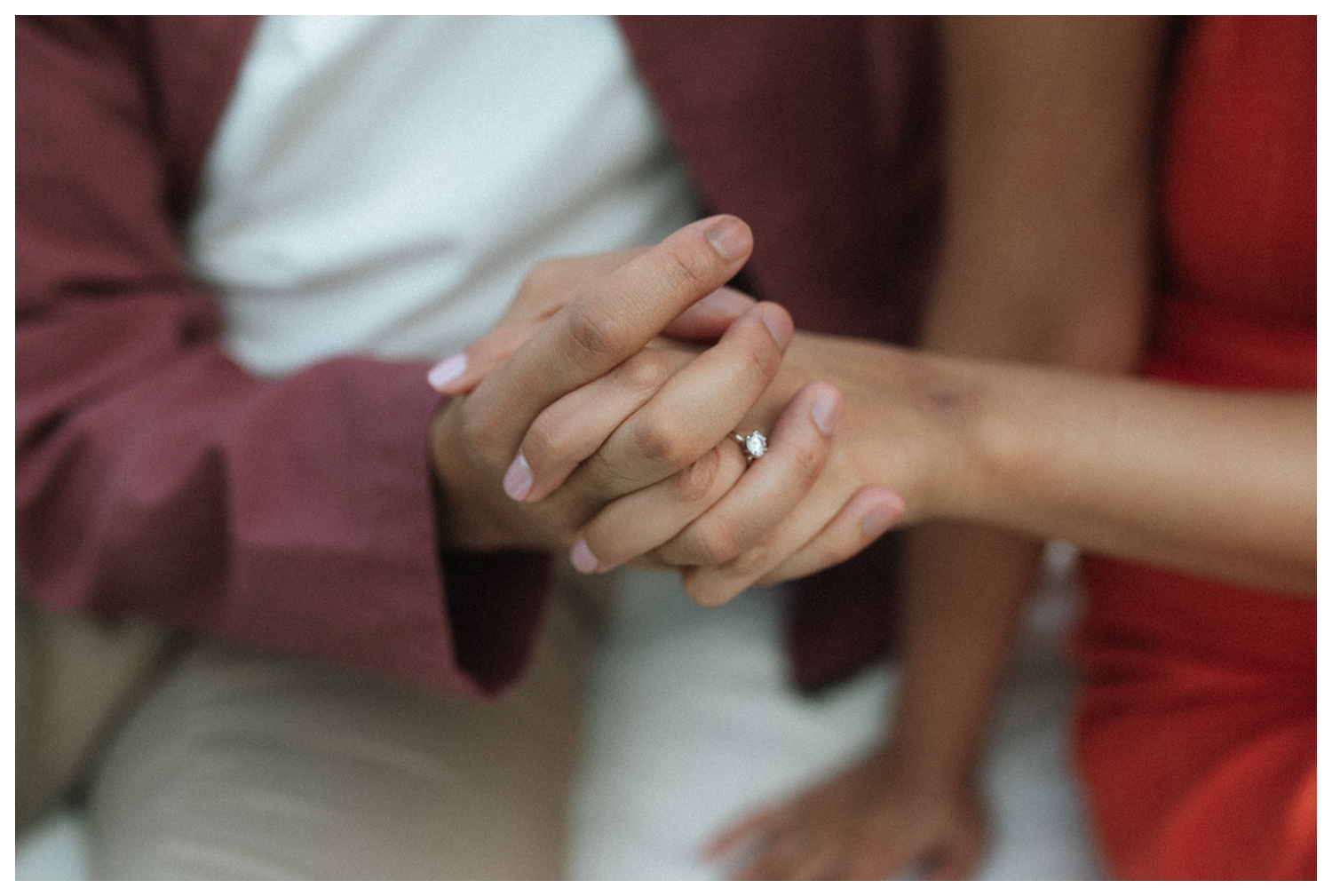 A candid moment of a couple sitting on a blanket, holding hands at Sheep Meadow in Central Park NYC. Parr Photo Co. NYC wedding photographer. Brooklyn Wedding Photographer.