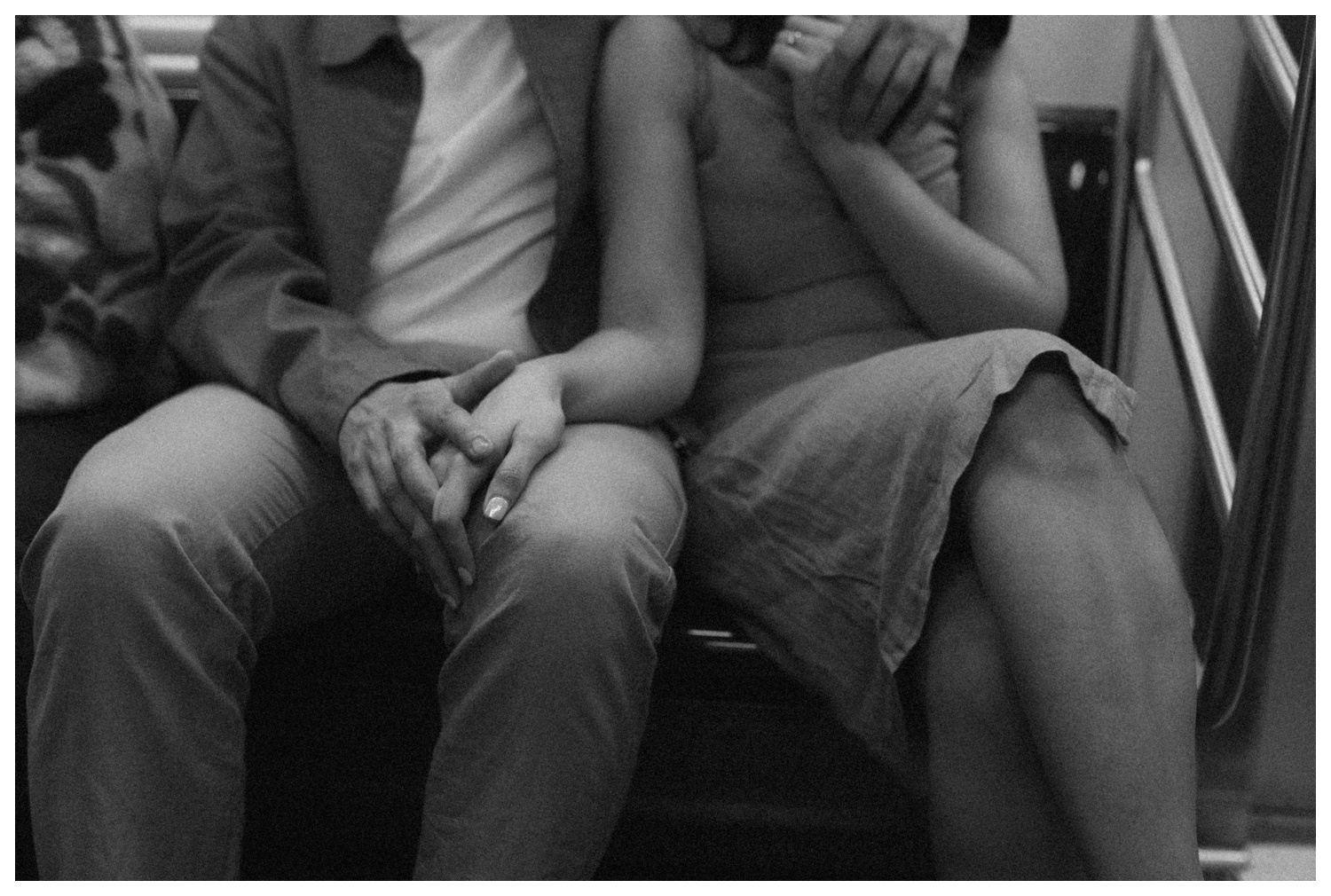 An engaged couple cuddling on the subway from Central park to the West Village