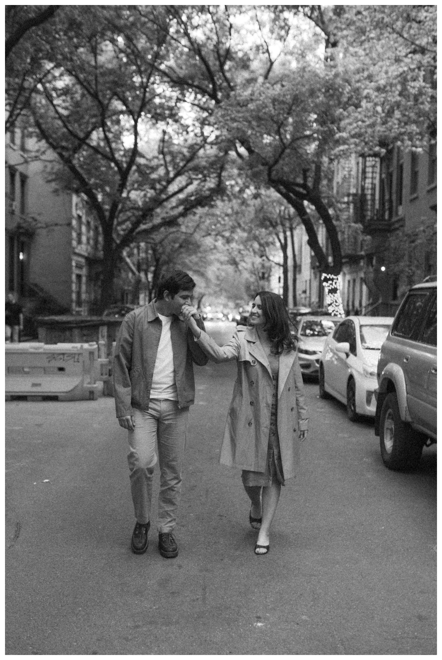 A couple walking down the cinematic streets of the West Village. NYC Wedding Photographer. Brooklyn Wedding Photographer.