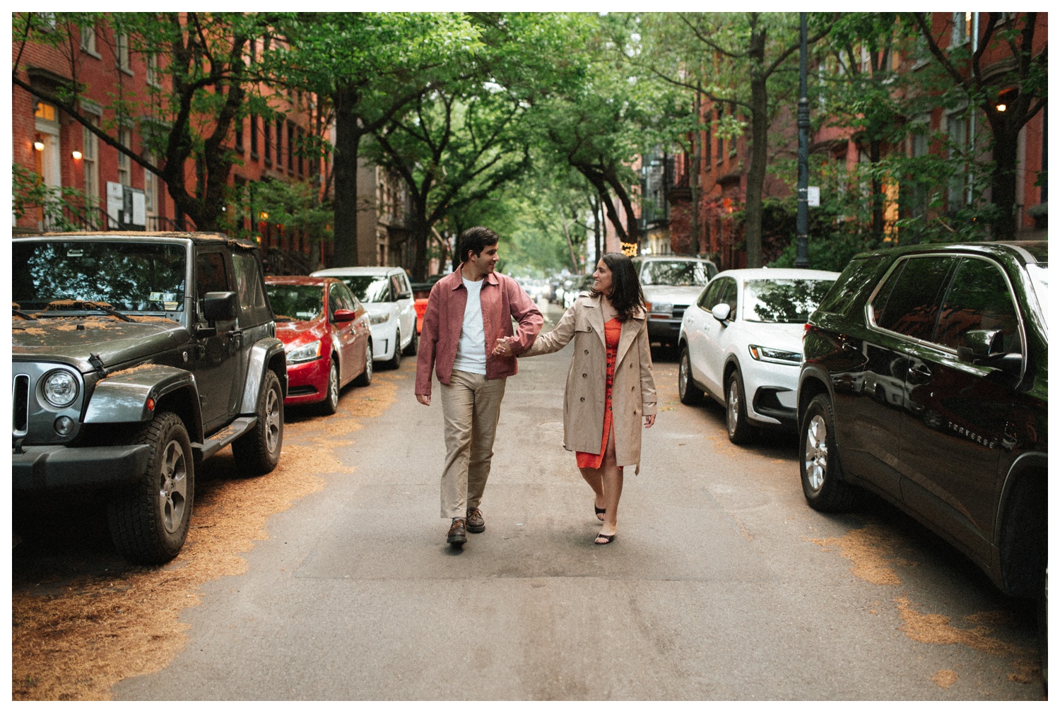 A couple walking down the cinematic streets of the West Village. NYC Wedding Photographer. Brooklyn Wedding Photographer.