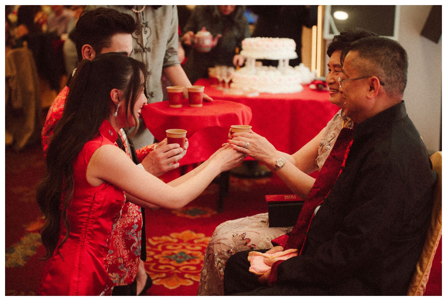 Bride and groom serving tea to elders at the traditional tea ceremony in Chinatown at House Of Joy. NYC Wedding photographer. Parr Photo Co