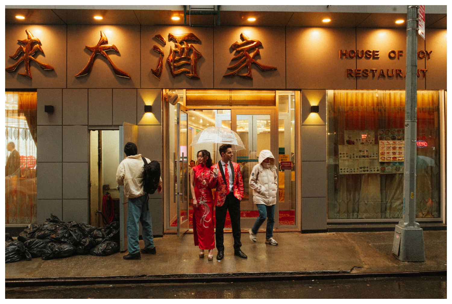 A couple taking portraits on the streets of chinatown in NYC for their tea ceremony at House Of Joy. NYC Wedding Photographer. Parr Photo Co