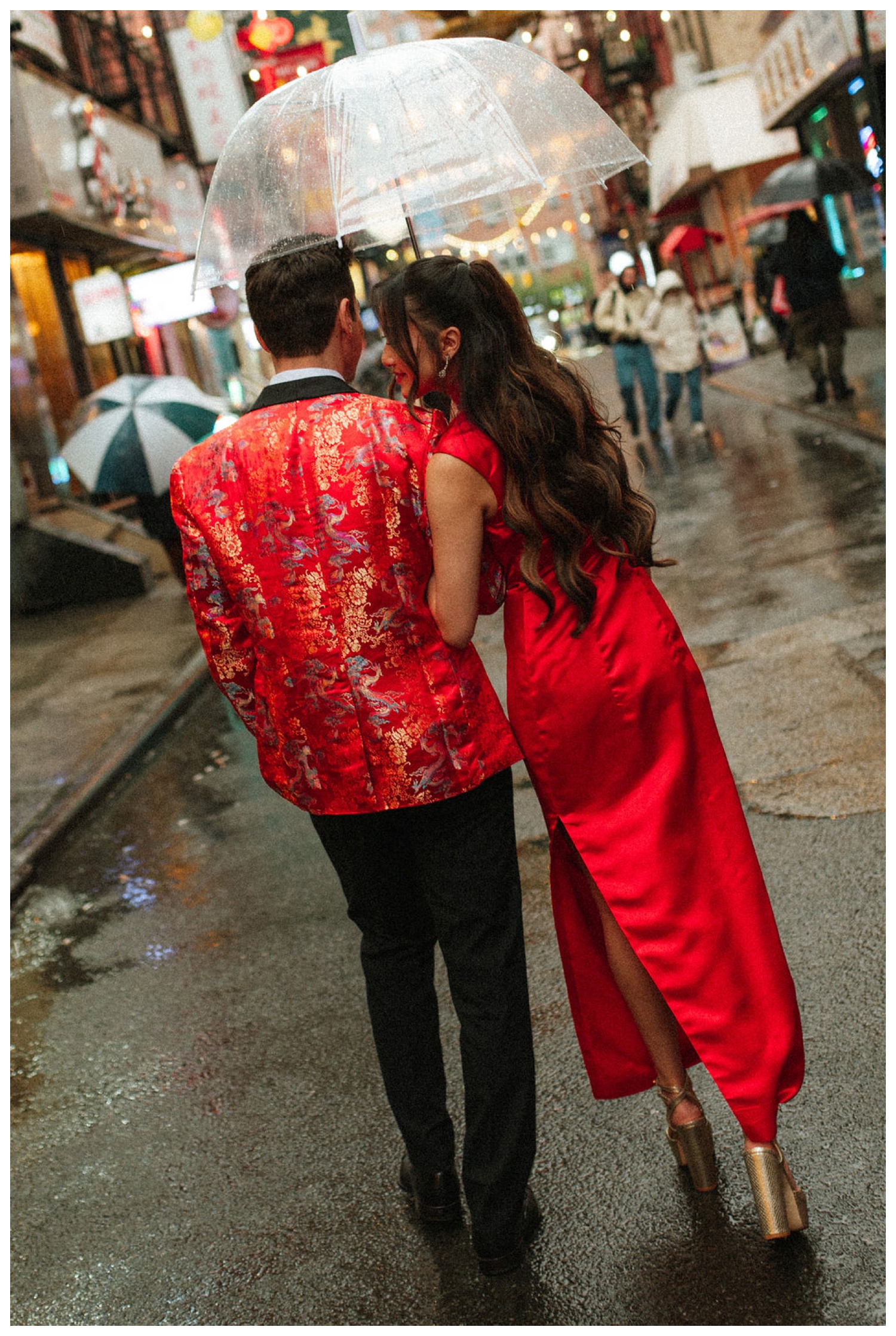 A couple taking portraits on the streets of chinatown in NYC for their tea ceremony at House Of Joy. NYC Wedding Photographer. Parr Photo Co