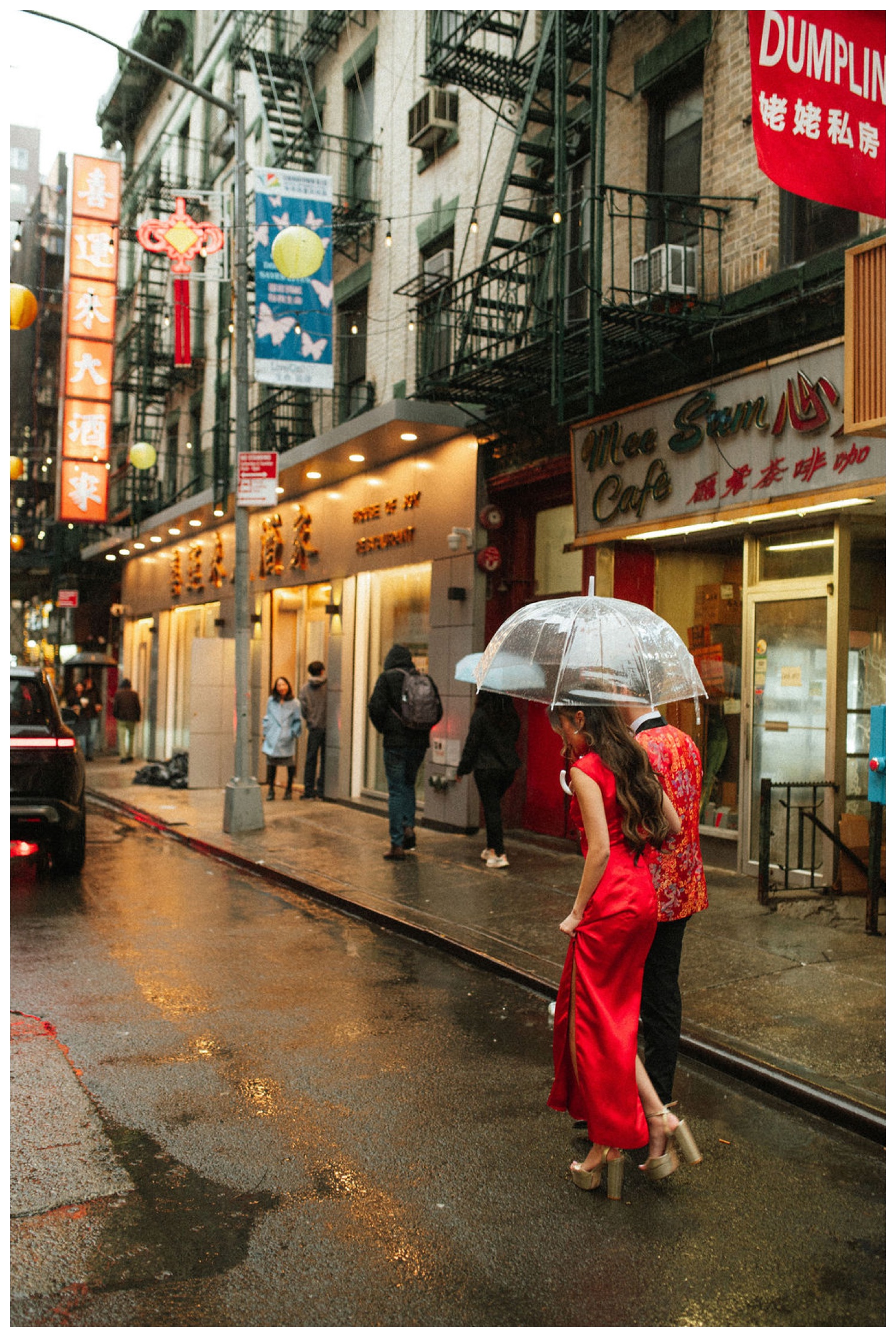 A couple taking portraits on the streets of chinatown in NYC for their tea ceremony at House Of Joy. NYC Wedding Photographer. Parr Photo Co